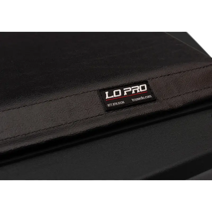 Black leather wallet with logo on Truxedo 05-15 Toyota Tacoma truck bed cover.