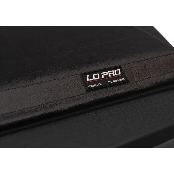 Black leather wallet displayed in Truxedo 05-15 Toyota Tacoma 5ft Lo Pro bed cover product.