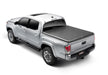 Truxedo 05-15 toyota tacoma 5ft truxport truck bed cover displayed in the back of a truck