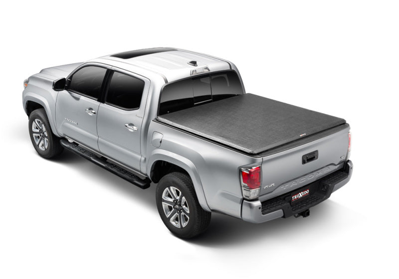 Truxedo 05-15 toyota tacoma 5ft truxport truck bed cover displayed in the back of a truck