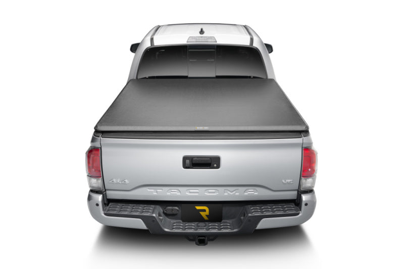 Silver truck displaying truxedo 05-15 toyota tacoma 5ft truxport bed cover from the back