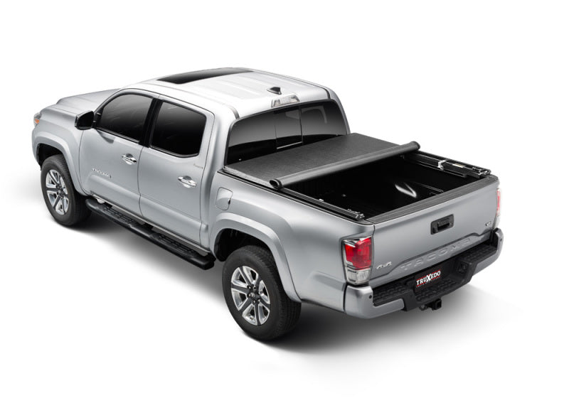 Truxedo 05-15 toyota tacoma 5ft truxport truck bed cover displayed in the back of a truck