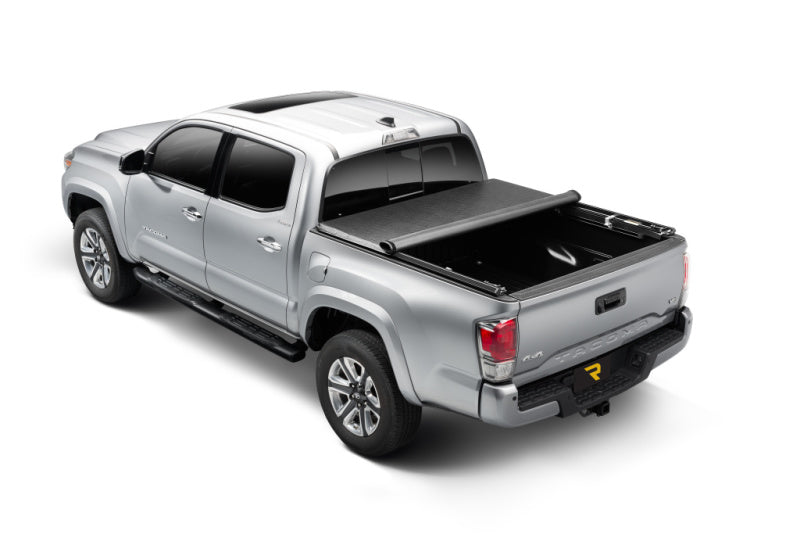 Truxedo 05-15 toyota tacoma 5ft truxport bed cover with truck bed displayed in the back