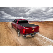 Red truck driving down dirt road - Truxedo Pro X15 Bed Cover for Toyota Tacoma