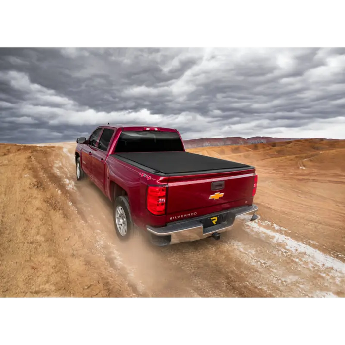 Red truck driving down dirt road - Truxedo Pro X15 Bed Cover for Toyota Tacoma