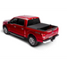 Red truck with black bed cover by Truxedo Pro X15 for Toyota Tacoma.