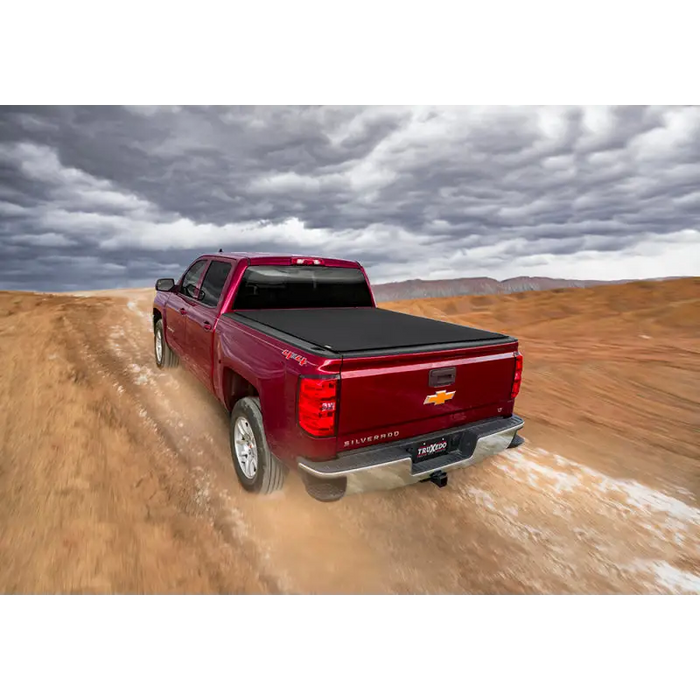 Red truck driving down dirt road - Truxedo 16-20 Toyota Tacoma Pro X15 Bed Cover.