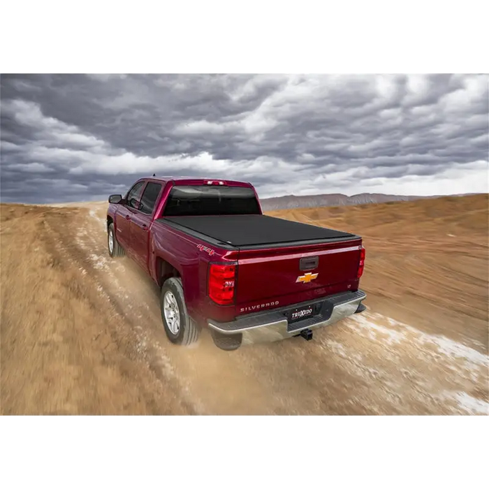 Red truck driving down dirt road - Truxedo Pro X15 Bed Cover installation instructions.