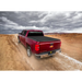 Red truck driving down dirt road with Truxedo Pro X15 Bed Cover