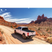 Truck driving down dirt road with Truxedo 2020 Jeep Gladiator 5ft Sentry CT Bed Cover.