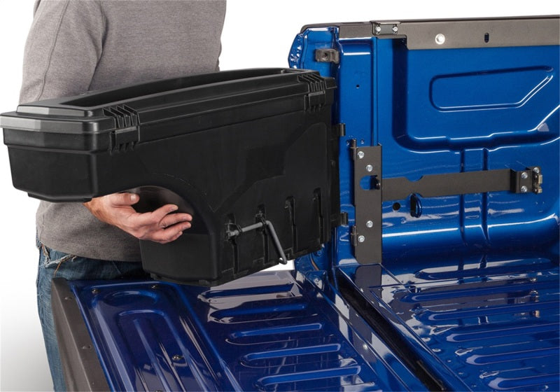 Man holding a tool box in hand for undercover toyota tacoma swing case - black smooth