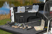 Undercover toyota tacoma drivers side swing case with fishing gear and rod in truck bed