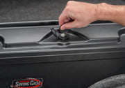 Man opening door to black truck bed swing case for toyota tacoma in product ’undercover 05-20 toyota tacoma drivers side swing case - black smooth’