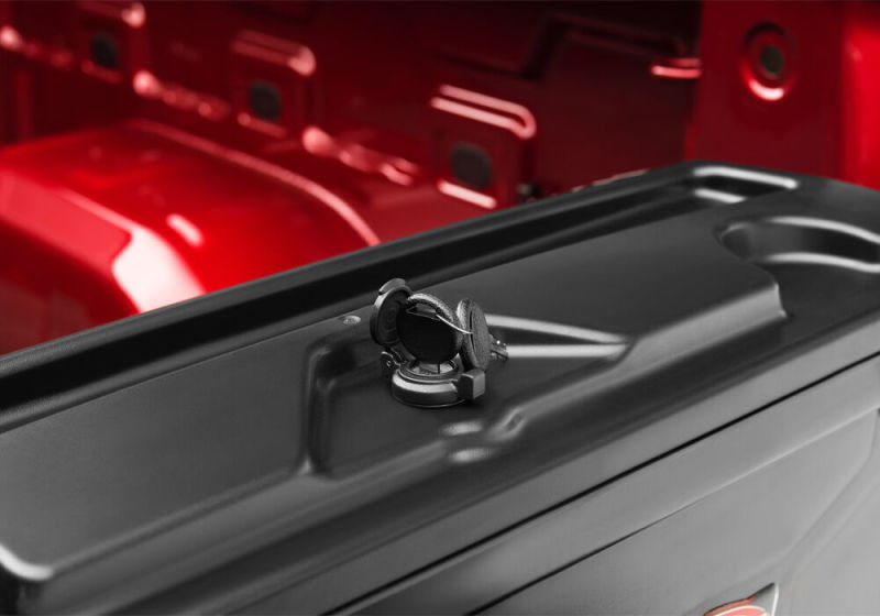Engine compartment of a red truck bed accessory - undercover 05-20 toyota tacoma passenger side swing case