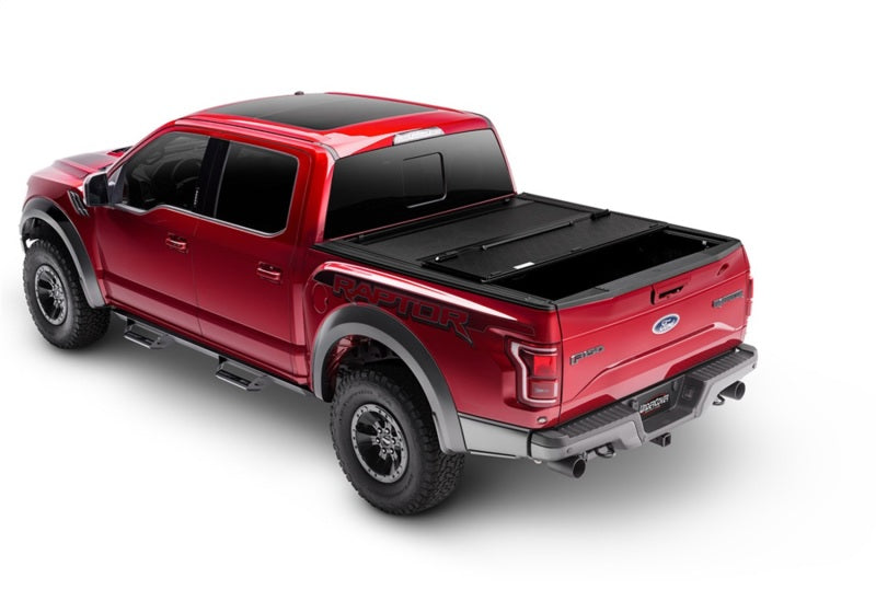 Red truck with black bed cover by undercover 16-20 toyota tacoma 5ft armor flex - black textured