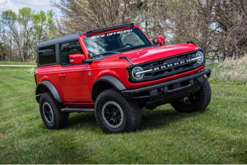 Red ford bronco 2in lift kit truck parked in field