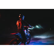 Man riding motorcycle in the dark with rigid industries single light cover for adapt xp - black