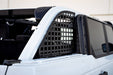 White ford bronco rear window molle panels with black roof rack.