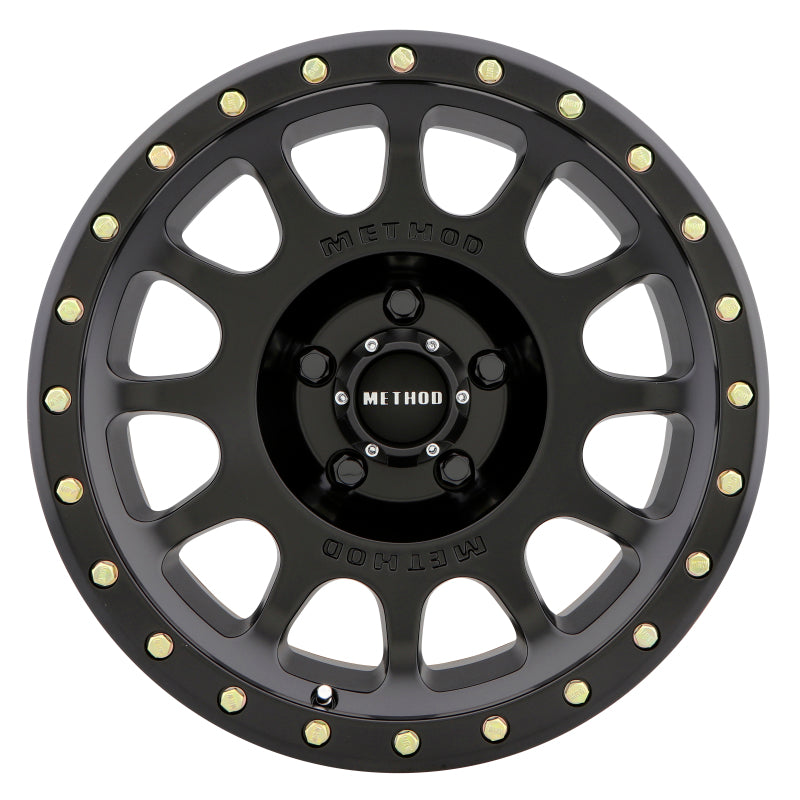 Method mr305 nv 17x8.5 0mm offset 5x150 matte black and gold wheel on white background