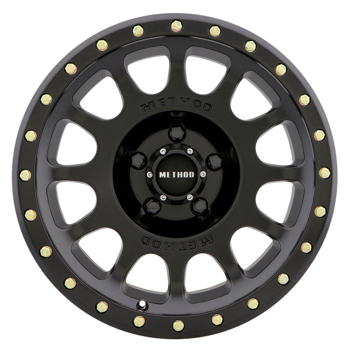 Method mr305 nv 20x9 matte black and gold wheel with white background